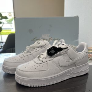 高松市のトレリバで買取したNOCTA×ナイキのエアフォース1。水色の限定BOXの前に置かれた白いスニーカーの画像。